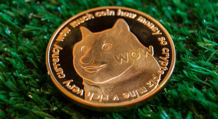 A stock image of a gold Dogecoin (DOGE) on a green textured background.