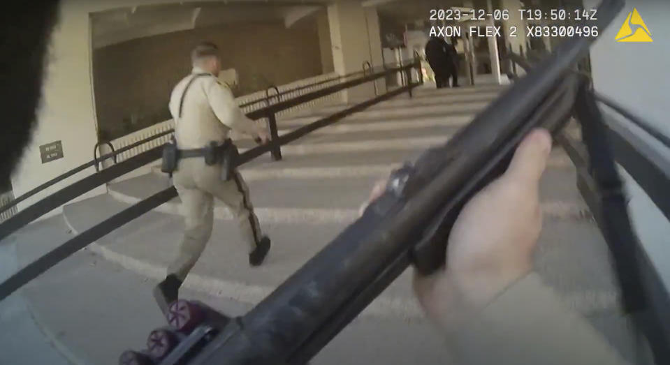 In this image made from body camera footage provided by the Las Vegas Metro Police Department, officers run into a building on the University of Nevada, Las Vegas campus, Wednesday, Dec. 6, 2023, in response to reports of a shooting. Police body camera footage from the shooting, which left three people dead and one wounded, was released Wednesday, Dec. 20. (Las Vegas Metro Police Department via AP)