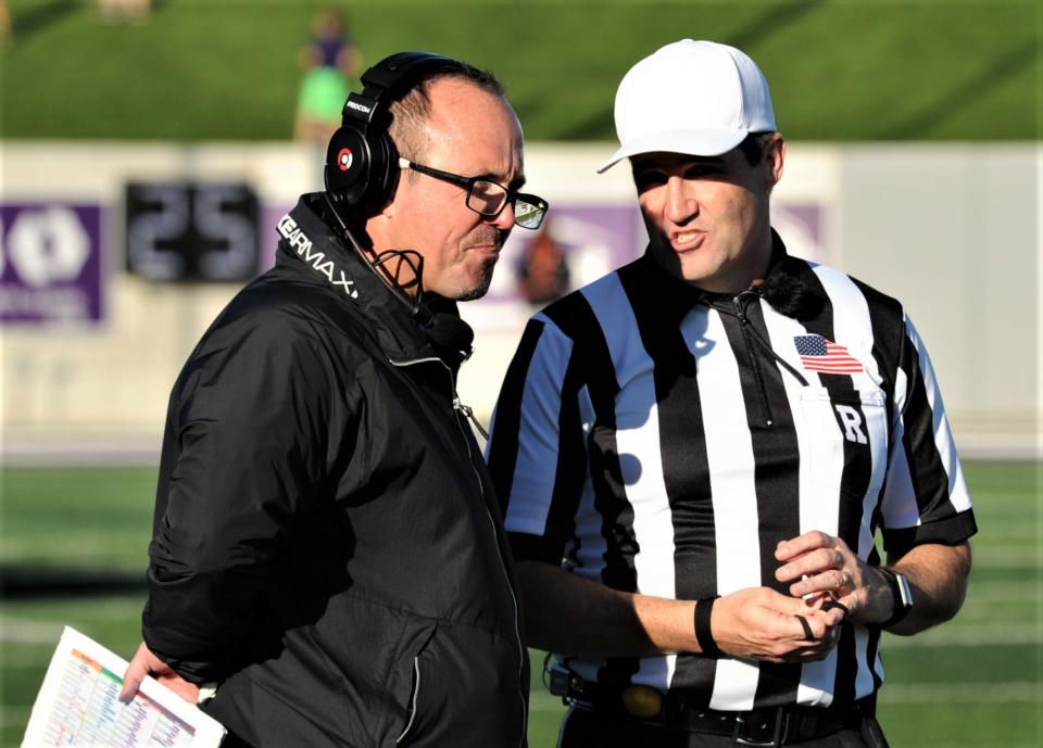 ACU coach Adam Dorrel, left, talks to an official during the Wildcats' game against Sam Houston State on Nov. 20 at Wildcat Stadium.