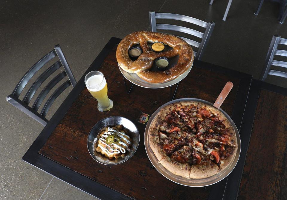 Among the selections at Beerhead Bar & Eatery: the Barbarian pretzel, Goodfella pizza and Tatchos