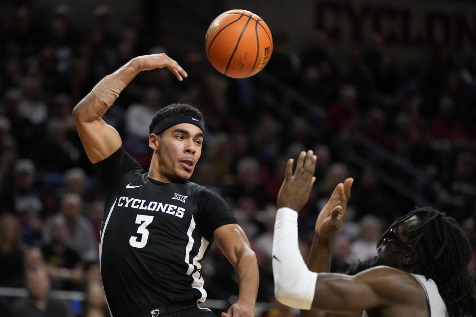 Iowa State guard Tamin Lipsey (3) passes over New Hampshire forward Promise Opurum, right, during the second half of an NCAA college basketball game, Sunday, Dec. 31, 2023, in Ames, Iowa. (AP Photo/Charlie Neibergall)