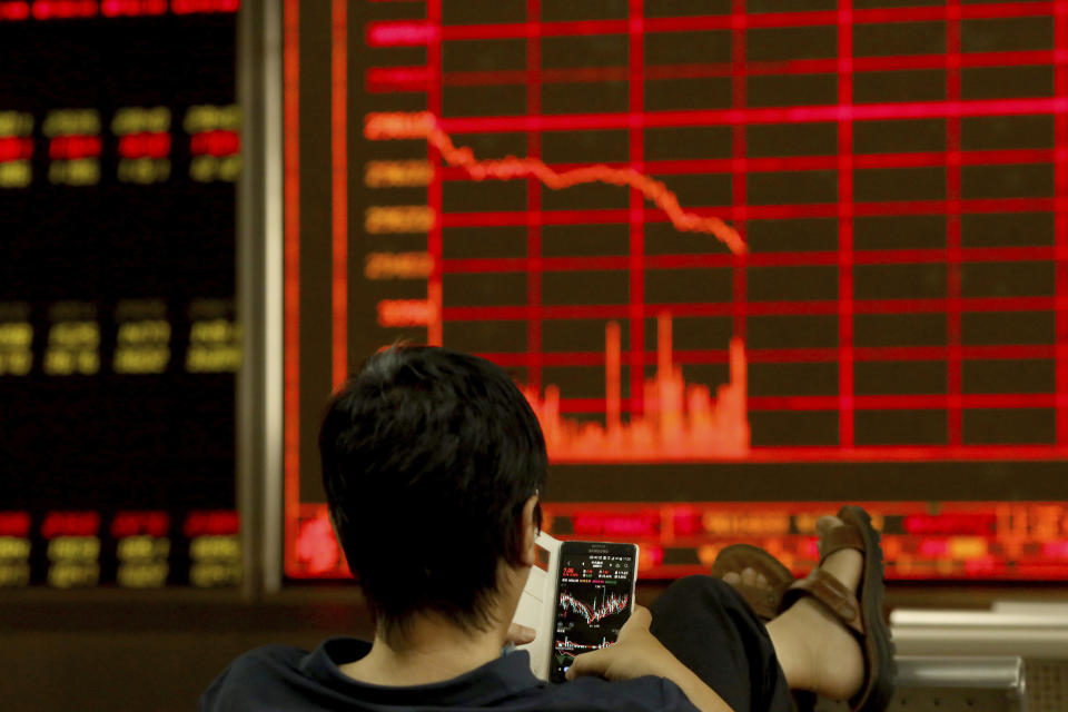 A man monitors stock prices at a brokerage in Beijing on Tuesday, June 25, 2019. Major Asian stock markets declined Tuesday as traders looked ahead to a meeting between the American and Chinese presidents amid hopes for renewed trade talks. (AP Photo/Ng Han Guan)