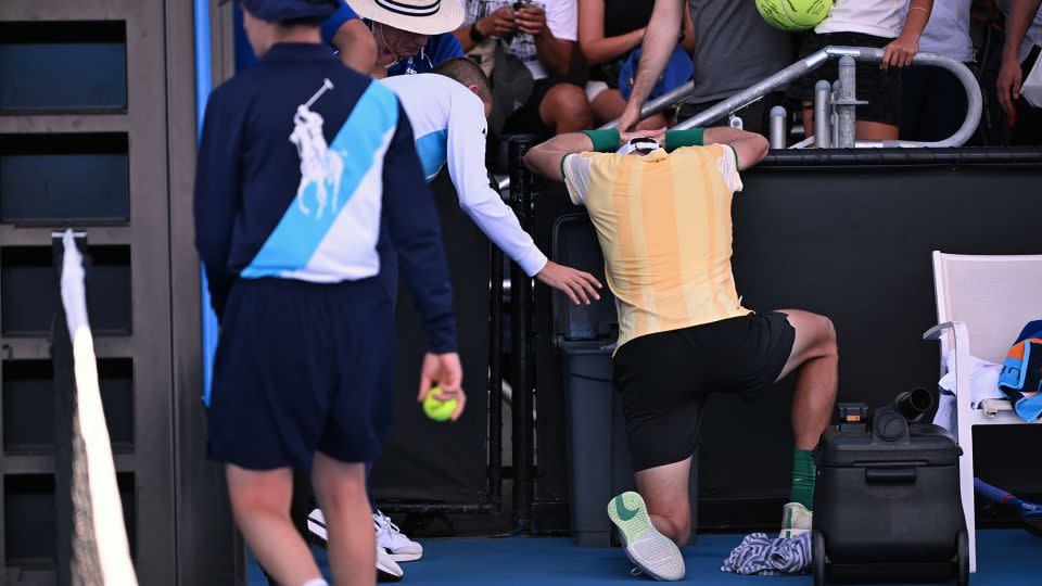 Draper vomits in a bin after his first-round victory in Melbourne. - William West/AFP/Getty Images