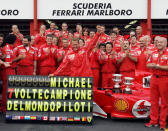 Schumacher celebrates, flanked by Ferrari technicians in the pits of the Spa-Francorchamps racetrack after the Belgium Grand Prix in Belgium. (Reuters)