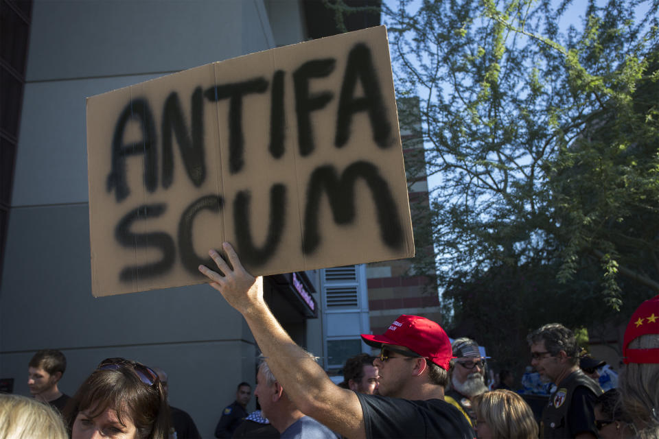 <p>A man standing in line to enter a rally by President Donald Trump carries a sign outside the Phoenix Convention Center on August 22, 2017 in Phoenix, Arizona. (David McNew/Getty Images) </p>