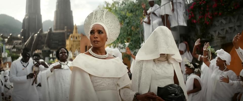 Angela Bassett walks in a procession in all white