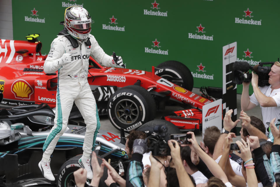 In this Nov. 11, 2018 photo, Mercedes driver Lewis Hamilton, of Britain, celebrates finishing first in the Brazilian Formula One Grand Prix at the Interlagos race track in Sao Paulo, Brazil. (AP Photo/Andre Penner)