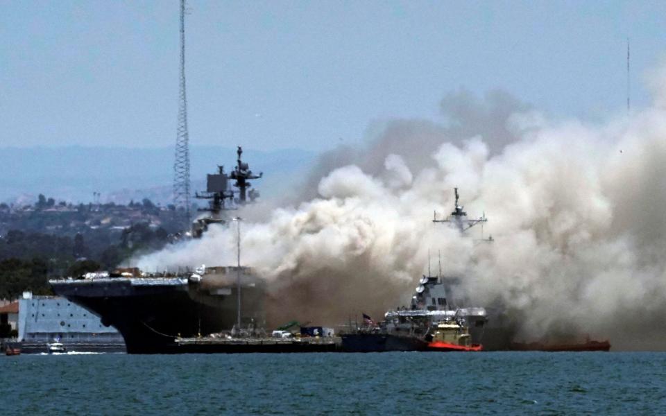 Smoke rises from a fire on board the US Navy amphibious assault ship USS Bonhomme Richard - Bing Guan/Reuters