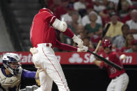 Los Angeles Angels' Shohei Ohtani, right, hits a two-run home run as Colorado Rockies catcher Elias Diaz watches during the sixth inning of a baseball game against the Colorado Rockies Tuesday, July 27, 2021, in Anaheim, Calif. (AP Photo/Mark J. Terrill)