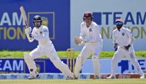Sri Lankan batsman Dhananjaya de Silva plays a shot as West Indies wicketkeeper Joshua Da Silva watches during the fourth day of their second test cricket match in Galle, Sri Lanka, Thursday, Dec. 2, 2021. (AP Photo/Eranga Jayawardena)
