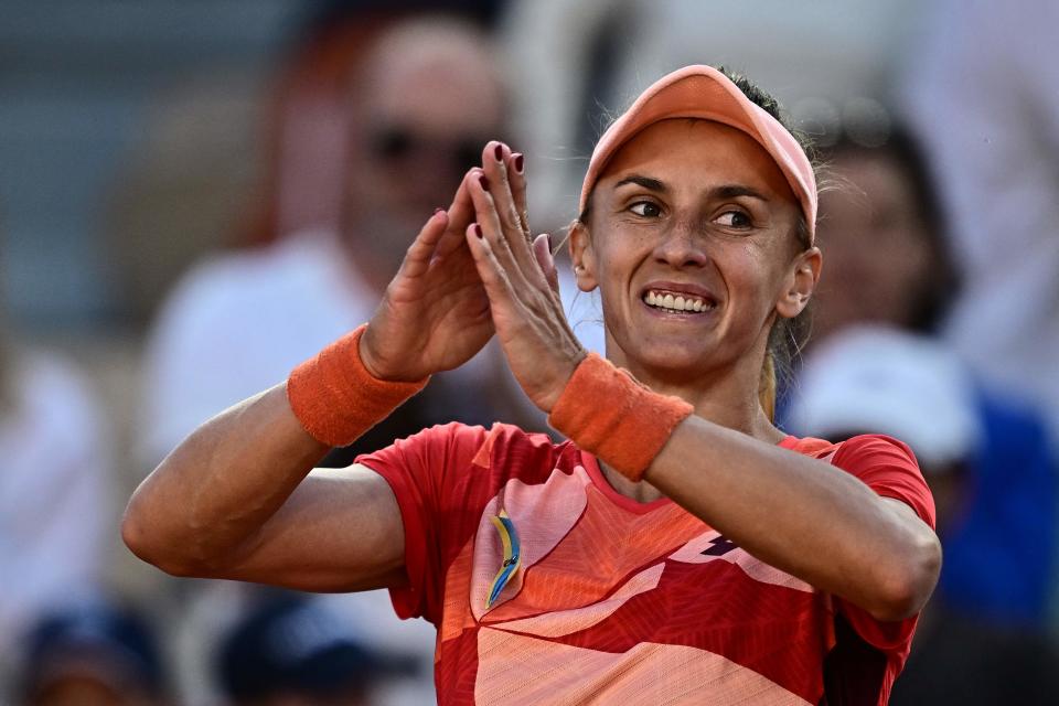 Ukraine's Lesia Tsurenko, with the Ukrainian national flag pinned on her jersey, celebrates her victory over Canada's Bianca Andreescu (AFP via Getty Images)