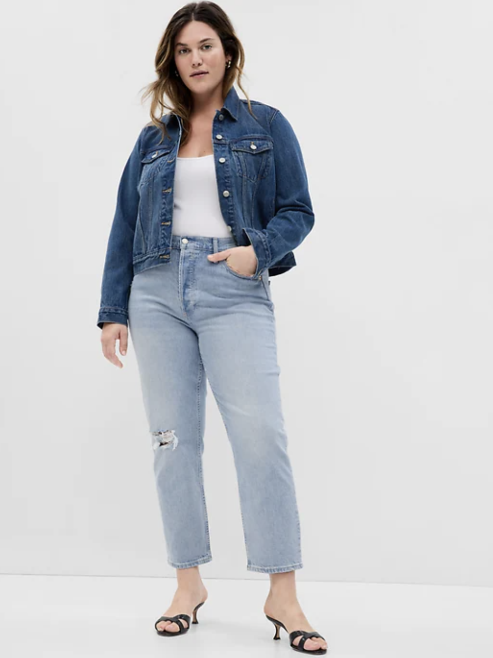 plus size model wearing white top, jean jacket and High Rise Cheeky Straight Jeans with Washwell (photo via Gap)