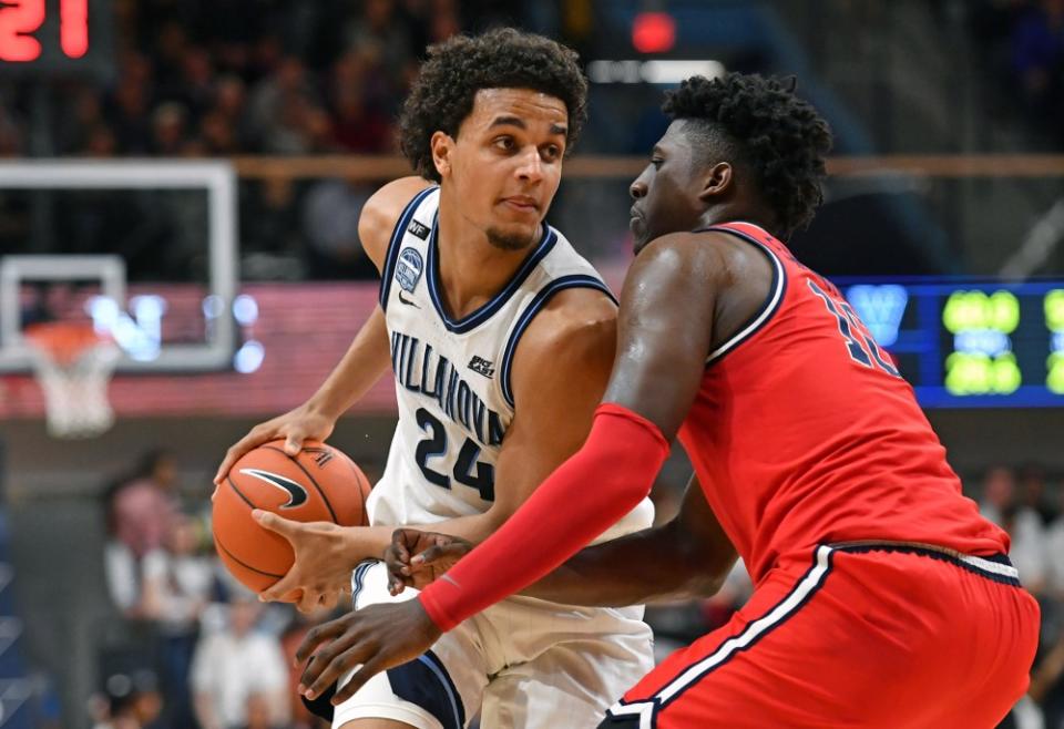 Feb 26, 2020; Villanova, Pennsylvania, USA; Villanova Wildcats forward Jeremiah Robinson-Earl (24) is defended by St. John's Red Storm forward Marcellus Earlington (10) during the first half at Finneran Pavilion.