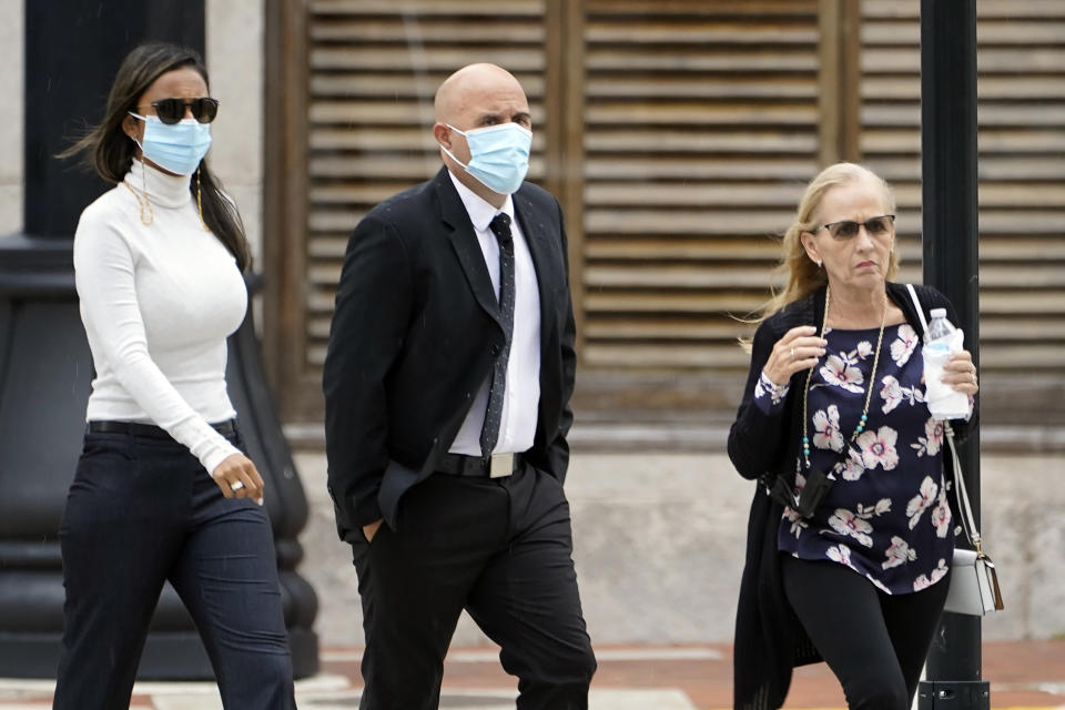 FILE - Former DEA agent Jose Irizarry, center, arrives at the United States Courthouse Thursday, Nov. 18, 2021, in Tampa, Fla. Irizarry, a once-standout U.S. narcotics agent who used his badge to build a lavish lifestyle of expensive cars, parties on yachts and Tiffany jewels, was sentenced to more than 12 years in federal prison on Thursday, Dec. 9, 2021, for conspiring to launder money with a Colombian cartel. (AP Photo/Chris O'Meara, File)