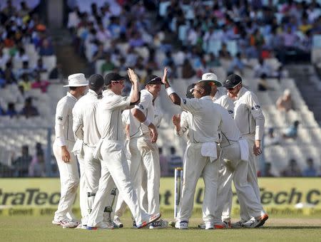 Cricket - India v New Zealand - Second Test cricket match - Eden Gardens, Kolkata, India - 30/09/2016. New Zealand's Jeetan Patel (3rd R) celebrates with his teammates after taking the wicket of India's Rohit Sharma. REUTERS/Rupak De Chowdhuri