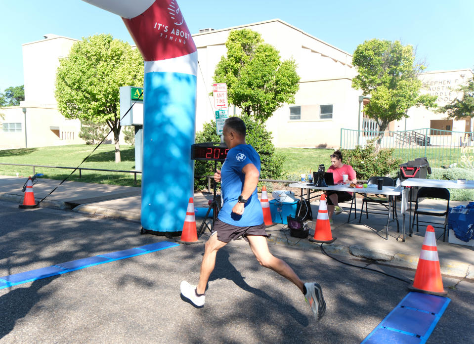 A runner finishes his run at just under 21 minutes at the Chief Petty Officer Jack R. Barnes Run For the Fallen Saturday morning at Stephen F Austin Park in Amarillo.