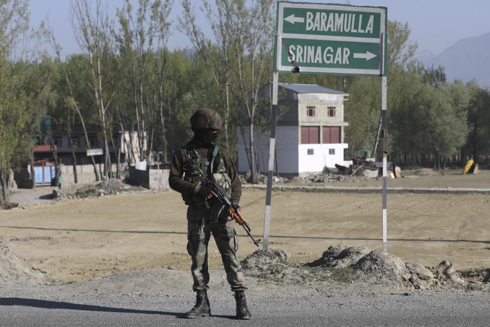An Indian army soldier stands guard on a highway on the outskirts of Srinagar, Indian controlled Kashmir, Sunday, Feb. 7, 2019. Authorities in Indian portion of Kashmir have banned civilian traffic on Srinagar-Jammu national highway for two days in a week for the safe passage of Indian security force convoys. The move comes after the February 14 suicide bombing on a paramilitary convoy which killed more than 40 paramilitary personnel. (AP Photo/Dar Yasin)