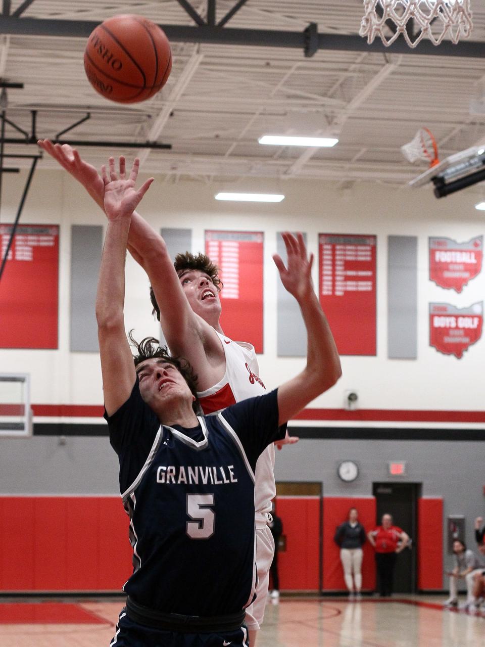 Granville junior Alex Engle and Johnstown junior Clayton Gearhart compete for a rebound Wednesday night during the Johnnies' 49-31 victory. 