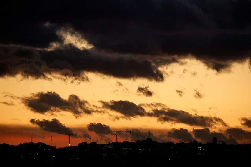 FILE PHOTO: Construction cranes are seen at dusk in Madrid