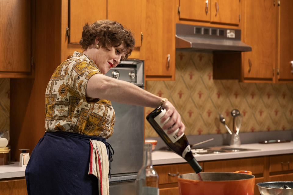 Julia Child pouring wine into a pot in Julia