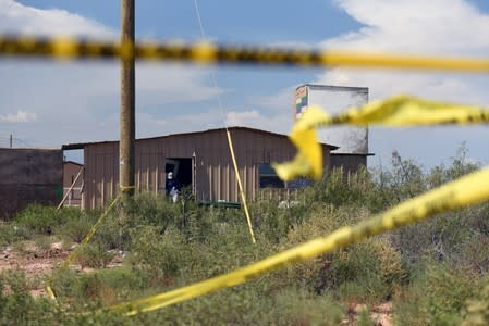 FBI agents investigate the home of Seth Ator following a shooting in Odessa