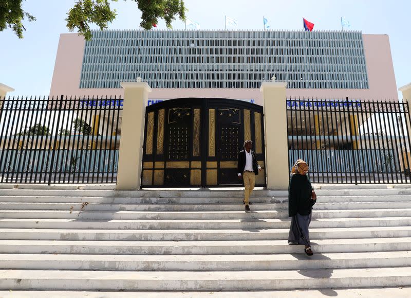 Civilians walk outside a renovated Somalia's National Theatre in Mogadishu