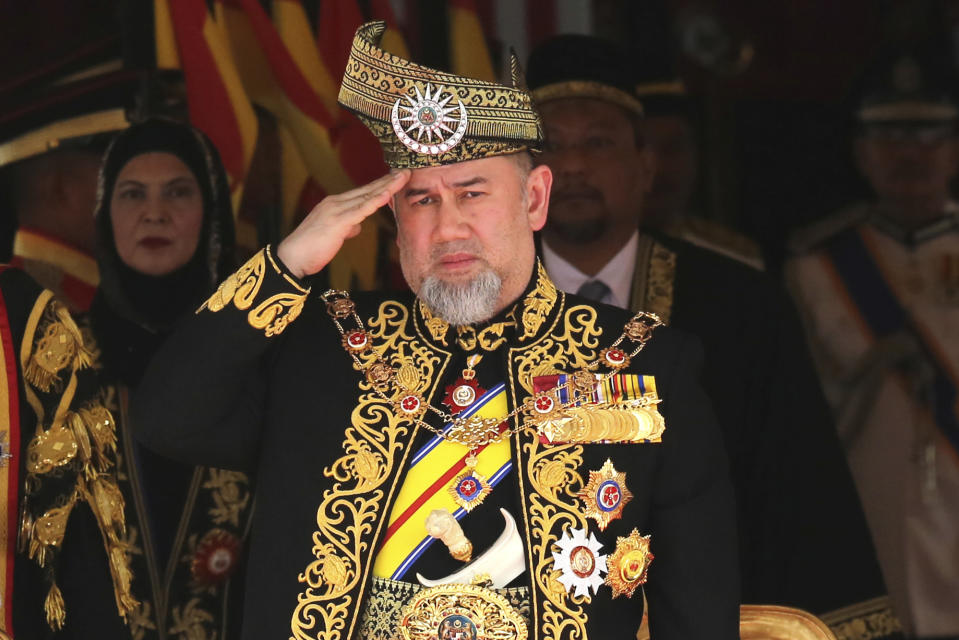 FILE - In this July 17, 2018, file photo, Malaysian King Sultan Muhammad V salutes during the national anthem at the opening of the 14th parliament session at the Parliament house in Kuala Lumpur, Malaysia. Muhammad V has abdicated in an unexpected and rare move, just after two years on the throne. The palace said in a statement on Sunday, Jan. 6, 2019, that Sultan Muhammad V, 49, has resigned with immediate effect, cutting short his five-year term, without giving any reasons. Sultan Muhammad V, ruler of northeast Kelantan state, was installed in December 2016 as one of the country's youngest constitutional monarchs. (AP Photo/Yam G-Jun, File)