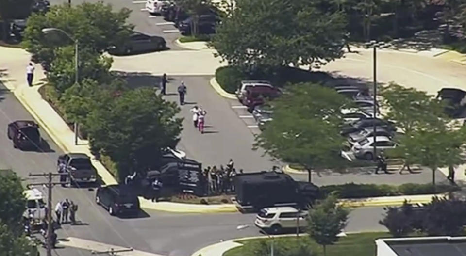 <p>In this frame from video, people leave the Capital Gazette newspaper after multiple people have been shot on Thursday, June 28, 2018, in Annapolis, Md. (Photo: WJLA via AP) </p>