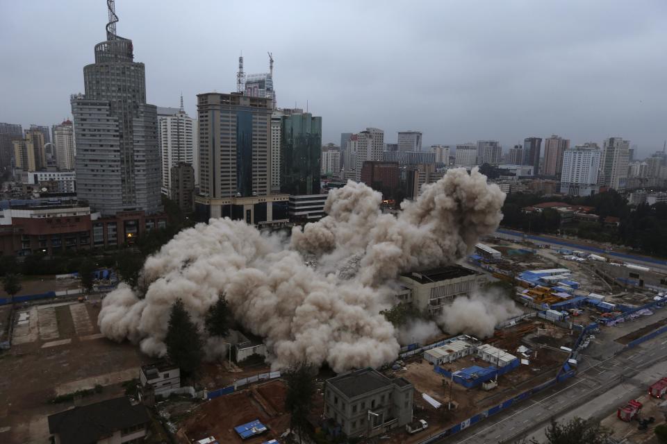 The Workers' Cultural Palace collapses after being demolished by explosives in Kunming, Yunnan province September 7, 2013. The 70-metre-high building has been a recreational center for residents since being completed in 1982. (REUTERS/Wong Campion)