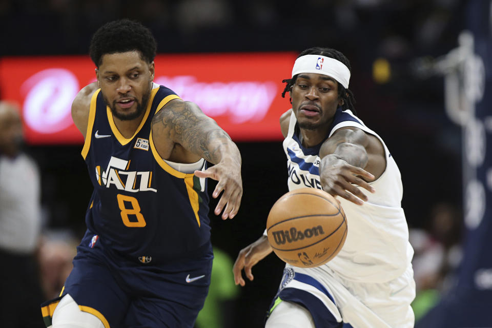 Minnesota Timberwolves forward Jarred Vanderbilt (8) and Utah Jazz forward Rudy Gay (8) go after a loose ball during the second half of an NBA basketball game Wednesday Dec. 8, 2021, in Minneapolis. Utah won 136-104. (AP Photo/Stacy Bengs)