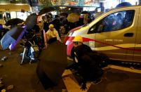 A taxi stops as anti-government demonstrators block a street during a protest at Tsim Sha Tsui, in Hong Kong