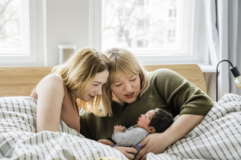 new moms laying in bed with their little baby