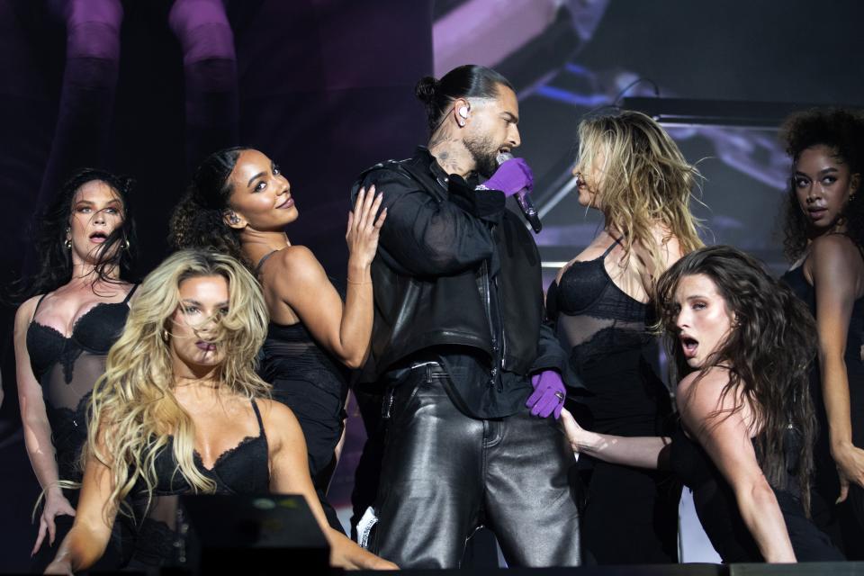 Colombian singer Maluma, center, performs during the Coca-Cola Flow Fest music festival in Mexico City, Monday, Nov. 27, 2023. (AP Photo/Alejandro Godinez)