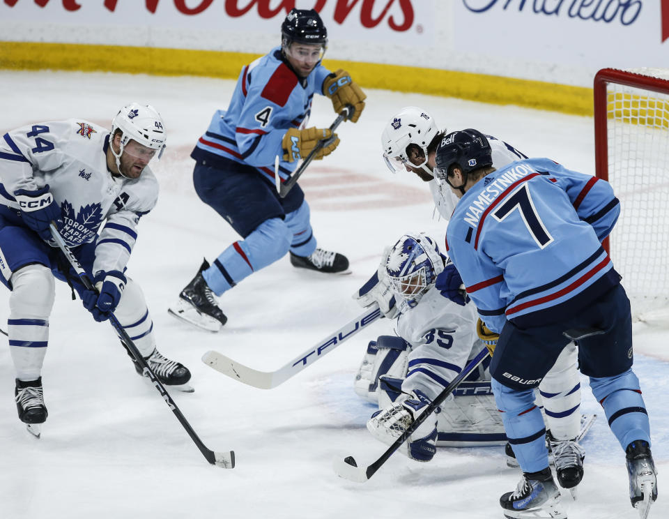 Toronto Maple Leafs goaltender Ilya Samsonov (35) saves the shot as Morgan Rielly (44) and TJ Brodie (78) defend against Winnipeg Jets' Neal Pionk (4) and Vladislav Namestnikov (7) during the second period of an NHL hockey game, Saturday, Jan. 27, 2024, in Winnipeg, Manitoba. (John Woods/The Canadian Press via AP)