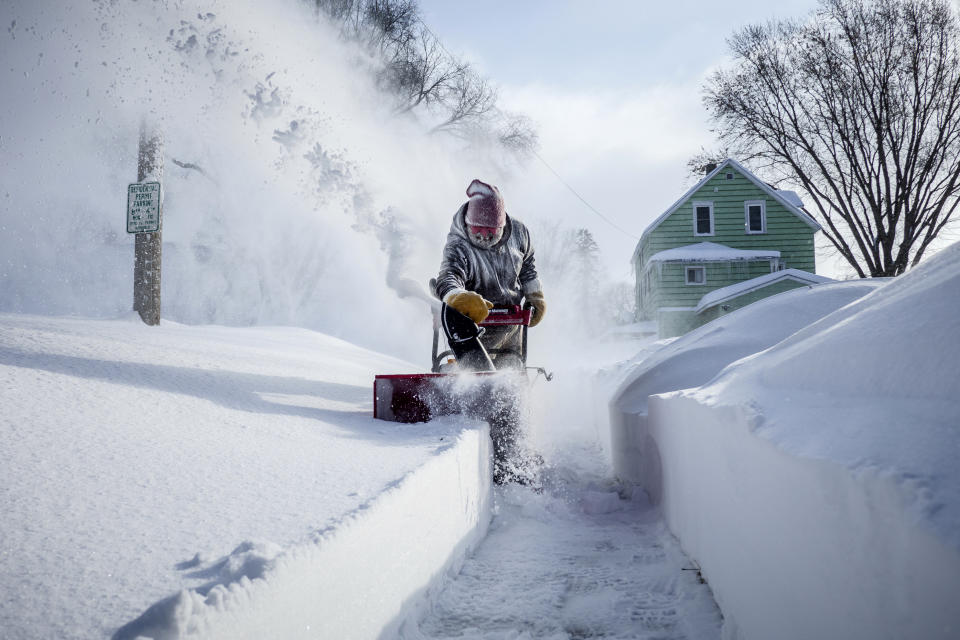 Michael Mueller snow blows the sidewalk near his house Sunday, Feb. 24, 2019, in Rochester, Minn., after heavy snow overnight. ( Joe Ahlquist/The Rochester Post-Bulletin via AP)