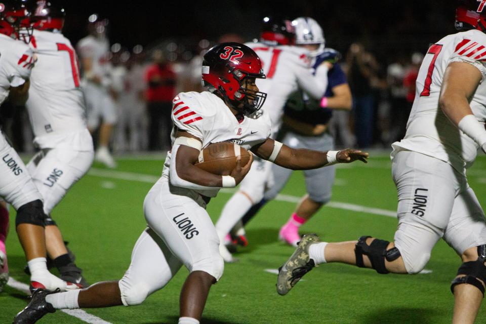 Running back Jon Wilson pushes through players at Pinnacle high football stadium in Phoenix on Oct. 6, 2023.