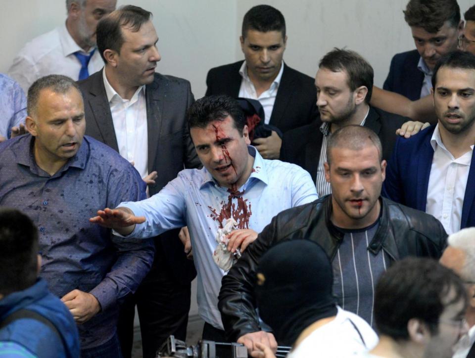 Opposition Social Democrats leader Zoran Zaev bleeds after being injured in the chaos (EPA)