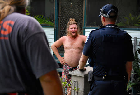 Police and Special Emergency Services (SES) advise a resident to evacuate in preparation for the arrival of Cyclone Debbie in the northern Australian city of Townsville, March 26, 2017. AAP/Dan Peled/via REUTERS