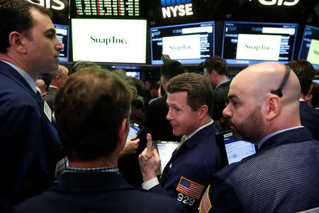 Traders laugh as they work on the floor of the New York Stock Exchange (NYSE) while waiting for Snap Inc. will post their IPO in New York, U.S., March 2, 2017. REUTERS/Lucas Jackson