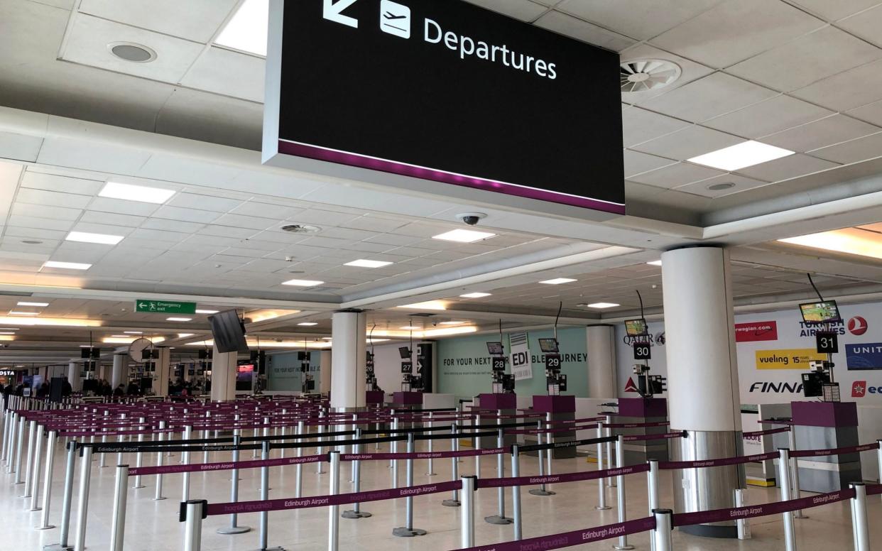 Empty check-in lines at Edinburgh Airport - PA