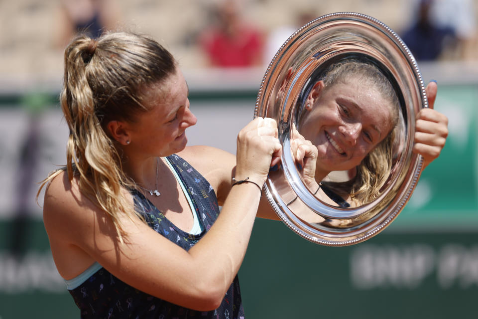 Czech Republic's Lucie Havlickova is reflected in her trophy during a ceremony after defeating Argentina's Solana Sierra in their girls final match of the French Open tennis tournament at the Roland Garros stadium Saturday, June 4, 2022 in Paris. Havlickova won 6-3, 6-3. (AP Photo/Jean-Francois Badias)