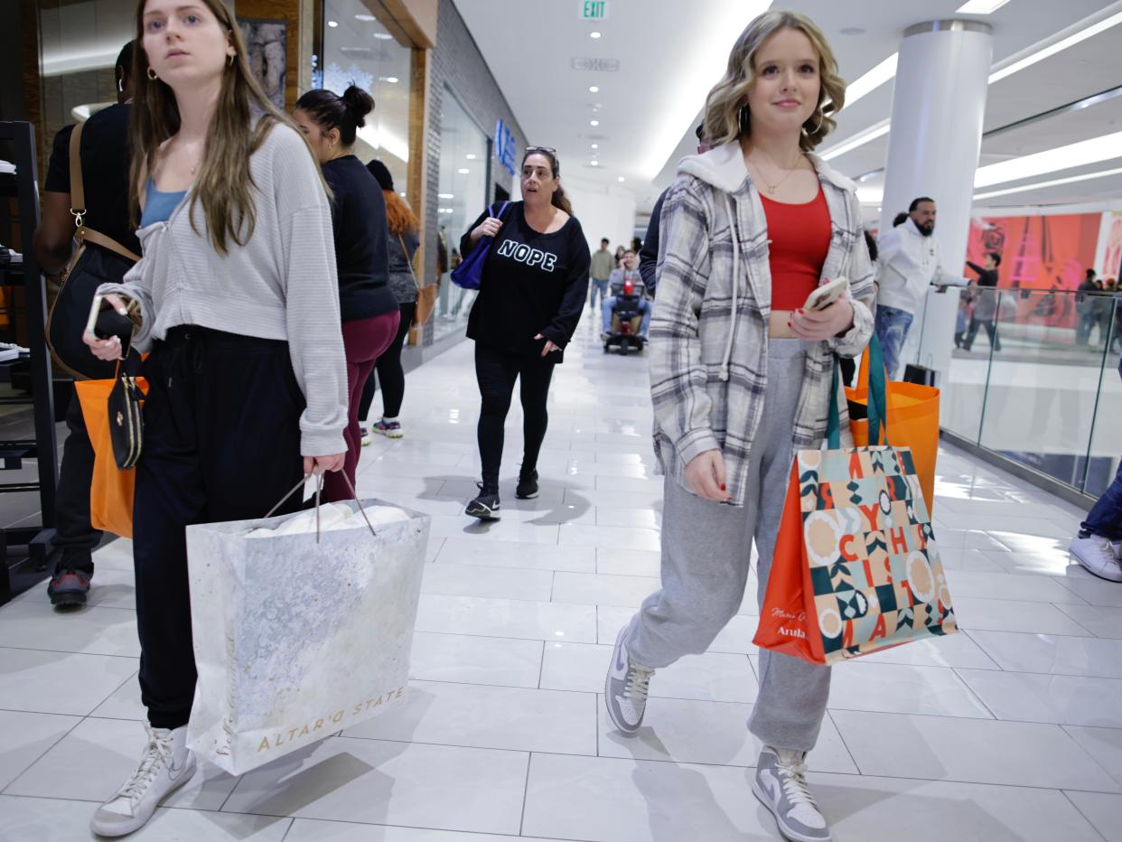 Shoppers walking through a mall.