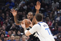 Dallas Mavericks guard Luka Doncic, right, tires to shoot as Los Angeles Clippers forward Kawhi Leonard defends during the first half in Game 2 of an NBA basketball first-round playoff series Tuesday, April 23, 2024, in Los Angeles. (AP Photo/Mark J. Terrill)