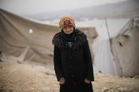 A Syrian woman poses for a photograph in a refugee camp for displaced people run by the Turkish Red Crescent in Sarmada district, on the outskirts north of Idlib, Syria, Thursday, Nov. 25, 2021. (AP Photo/Francisco Seco)