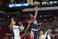 Houston Rockets forward Jae'Sean Tate (8) drives past Orlando Magic forward Chuma Okeke (3) during the first half of an NBA basketball game Friday, Dec. 3, 2021, in Houston. (AP Photo/Eric Christian Smith)