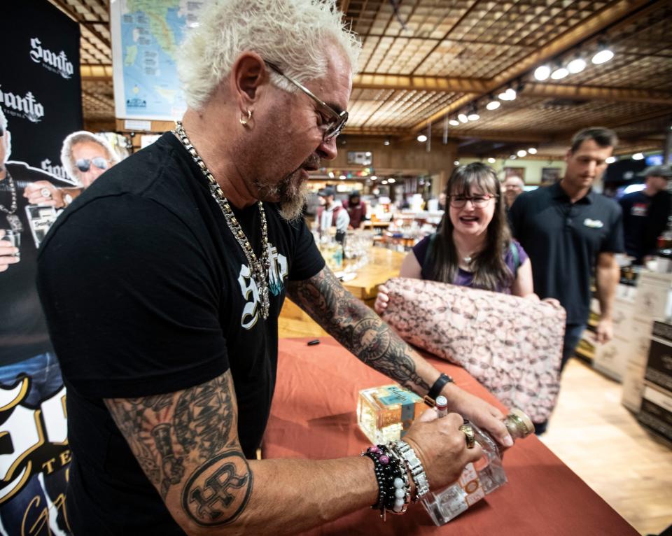 Celebrity restaurateur and television personality Guy Fieri signs a bottle of tequila for Christina Ferruggia of Tuckahoe as Fieri made an appearance in the liquor department at Stew Leonards supermarket in Yonkers May 5, 2024. Fieri was on hand to promote his new tequila, named Santo Tequila. Members of the Yonkers fire and police departments and about two-hundred fans showed up to have their photos taken with Fieri and have him sign bottles of his tequila.