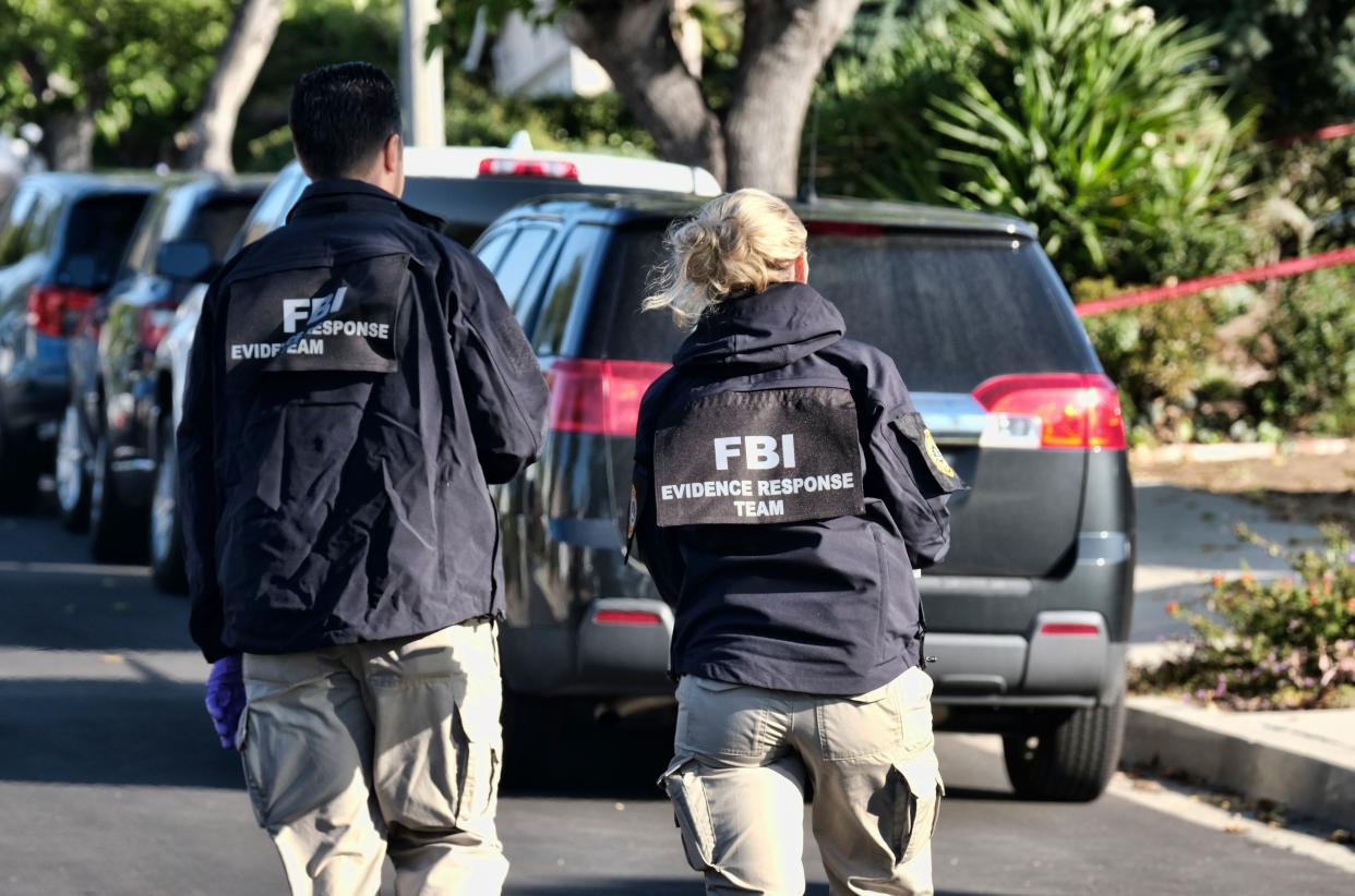 FBI investigators arrive outside the house of shooting suspect David Ian Long in Newbury Park, Calif., on Thursday, Nov. 8, 2018. Authorities said the former Marine opened fire at a country music bar in Southern California on Wednesday evening.