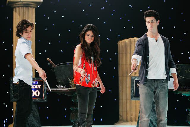 <p>Craig Sjodin/Disney Channel/Getty</p> Jake T. Austin, Selena Gomez, and David Henrie in the series finale of 'Wizards of Waverly Place'.