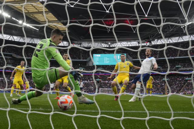 Ukraine's goalkeeper Anatoliy Trubin fails to save the goal from Englands' Harry Kane, right, during the Euro 2024 group C qualifying soccer match between England and Ukraine at Wembley Stadium in London, Sunday, March 26, 2023. (AP Photo/Alastair Grant)