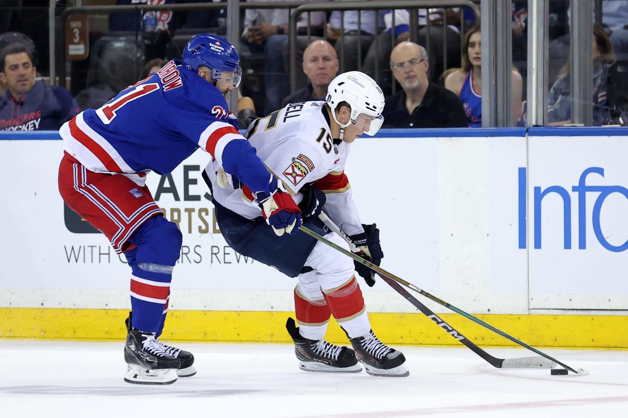 May 22, 2024; New York, New York, USA; Florida Panthers center Anton Lundell (15) skates with the puck against New York Rangers center Barclay Goodrow (21) during the second period of game one of the Eastern Conference Final of the 2024 Stanley Cup Playoffs at Madison Square Garden. Mandatory Credit: Brad Penner-USA TODAY Sports